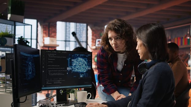 AI startup engineer asks questions to team leader before starting implementing machine learning. Artificial intelligence tech venture employee requests help from manager to fix code bugs, camera A