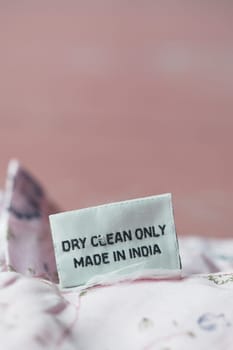 A clothing label indicates dry clean only instructions and origin in India.