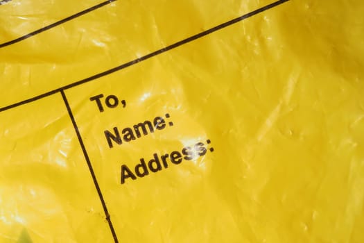 A yellow envelope with fields for recipient details like name and address.