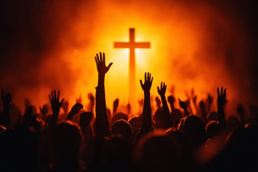 A large group of people raising hands in praise with a cross and illuminated light in the background..