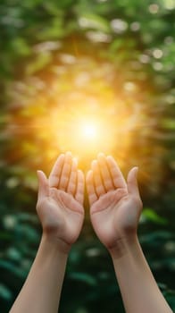 Woman holding her hands up to receive the light in a forest, spirituality and nature concept