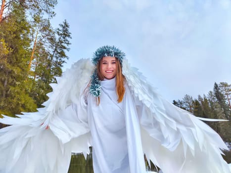 Two girls in white dresses pose gracefully by a serene lake, embodying winter spirits amidst a beautiful natural setting.