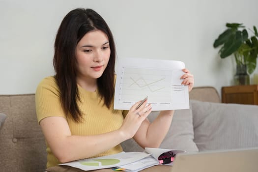 Showcasing her ability to analyze and present data, the woman actively engages in a virtual meeting, emphasizing the dynamics of modern remote work and effective communication.