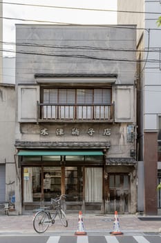 Traditional japanese shopfront preserving architectural heritage in urban setting