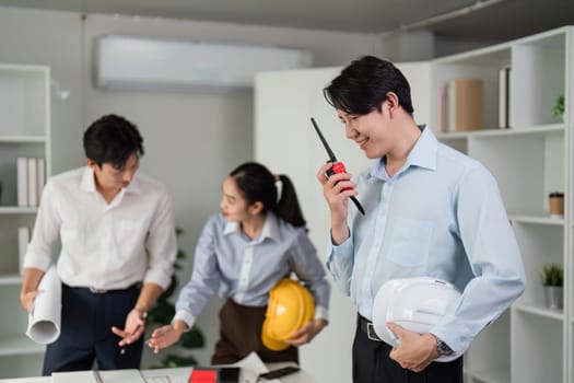 A close-knit team engages in meaningful dialogue, employing technology to enhance their teamwork and efficiently tackle project challenges.