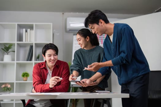 A vibrant design team collaborates at a table, sketching and sharing ideas on user experience and interface concepts, emphasizing creativity and teamwork.