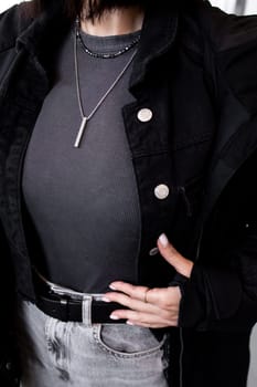 Fashionable female in black jacket and accessories.