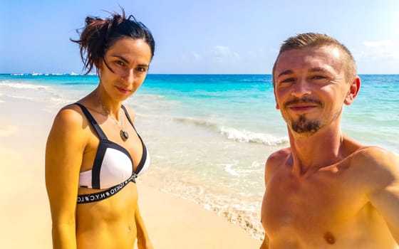 Couple man and woman together at the Caribbean beach and sea in Playa del Carmen Quintana Roo Mexico.