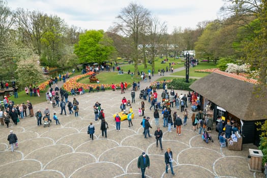 Lisse, Netherlands - April 17, 2019: Numerous people walk in a Keukenhof park View from above
