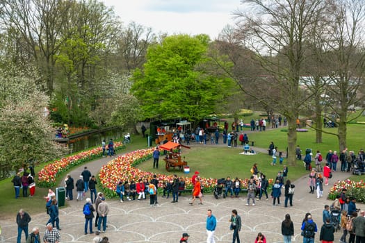 Lisse, Netherlands - April 17, 2019: Numerous people walk in a Keukenhof park View from above