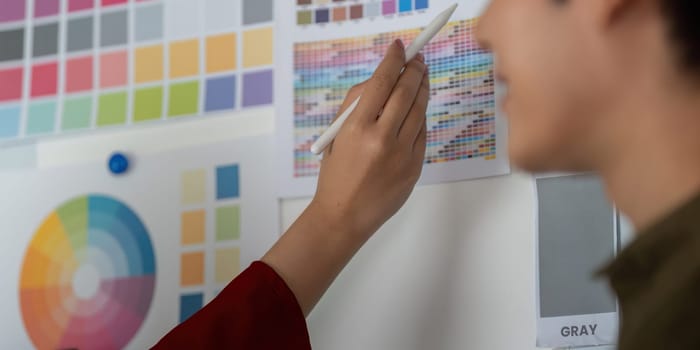 In a brainstorming session, a team member highlights color choices from an array of options, collaborating on visual elements for upcoming designs.