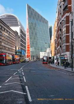 London, United Kingdom - February 02, 2019: Vauxhall bridge road, red buses on sides, with tall Nova Building at the end - modern glass and steel architecture designed by Benson + Forsyth, 