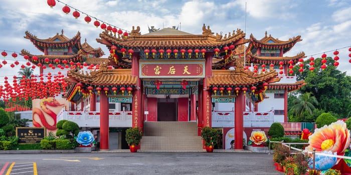 Thean Hou Temple, in Kuala Lumpur, Malaysia, showcases intricate architecture surrounded by bright red lanterns and colorful floral decorations