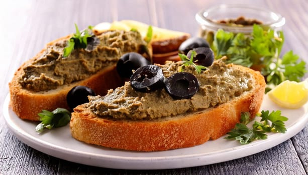 sliced bread with black olives pate spread topping AI generated image