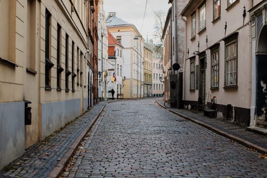 A beautiful European city square bathed in warm sunlight. The cobblestone pavement reflects the golden rays of the setting sun, while historic buildings with elegant facades frame the scene.
