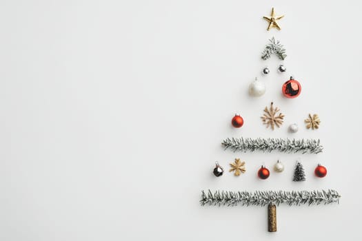 A festive display features a decorative tree crafted from tinsel and ornaments, celebrating the holiday spirit with elegance and charm.