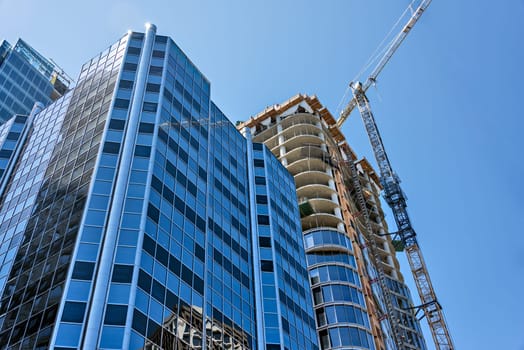 Monolite concrete building under constraction on blue sky background.