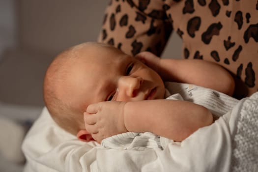 A loving mother embraces her newborn baby, showcasing a nurturing moment in a soft, warm atmosphere. The baby appears calm and peaceful.