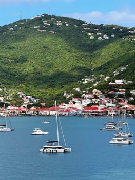St.Thomas, part of the U.S. Virgin Islands in the Caribbean Sea 10. 28, 2023 Anchored sailboats in the calm blue waters of Charlotte Amalie, surrounded by lush green hills and red-roofed buildings.