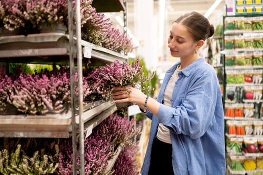 Happy Girl Chooses A Potted Flower In The Flower Department In Shop
