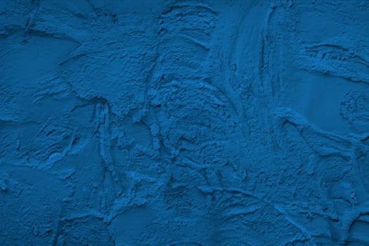 Abstract decorative dark blue plaster wall background
