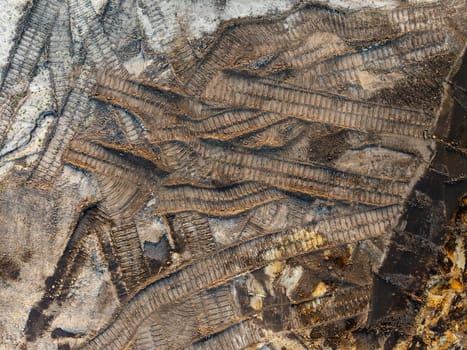 aerial top down view of bolldozer dirt tracks in the sand