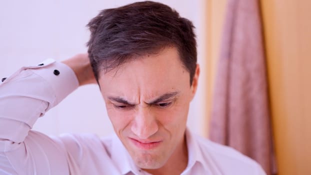 Man in white shirt expressing worry and stress