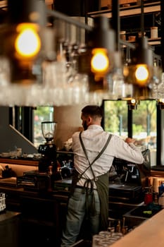 Dedicated barista expertly prepares espresso while engaging with a lively atmosphere filled with sunlight, plants, and happy customers savoring their drinks