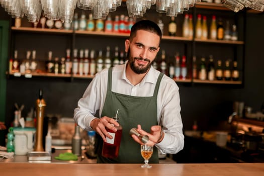 In a lively bar setting, a confident bartender mixes a fresh cocktail, showcasing his expertise with a bottle in hand, ready for the night's rush