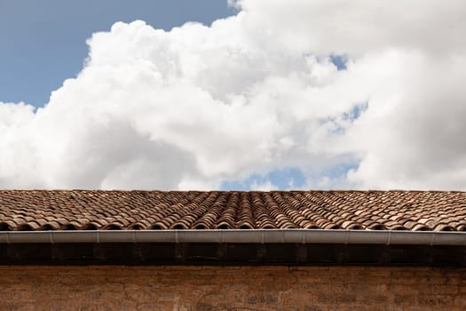 Cloudy sky above a tiled roof