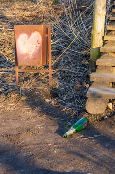 Outdoor trash bin with heart painted on it
