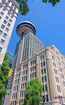 Tall tower with the view point on the top in downtown of Vancouver on blue sky background