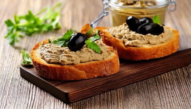 sliced bread with black olives pate spread topping AI generated image