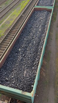 Coal being transported in an open wagon on railway tracks