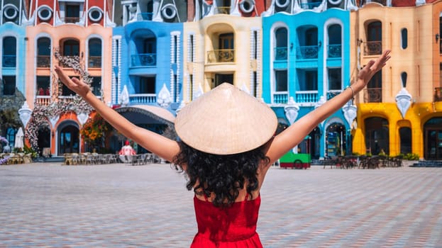 young woman tourist traveler in a Vietnamese hat Non La on Vinpearl Island at VinWonders Amusement Park in Nha Trang at summer vacation in Asia. Travel and tourism in Vietnam