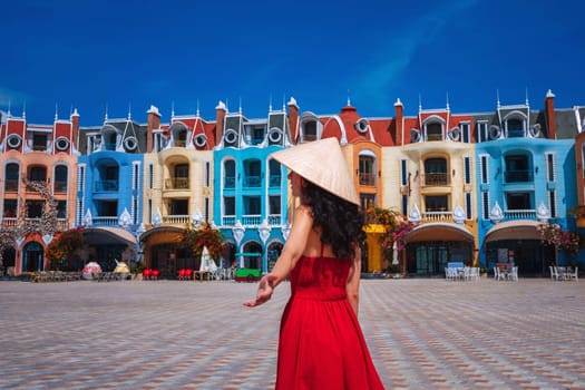 beautiful woman tourist traveler in Vietnamese hat on Vinpearl Island at VinWonders Amusement Park in Nha Trang at vacation in Asia. Travel and tourism in Vietnam. Follow me concept
