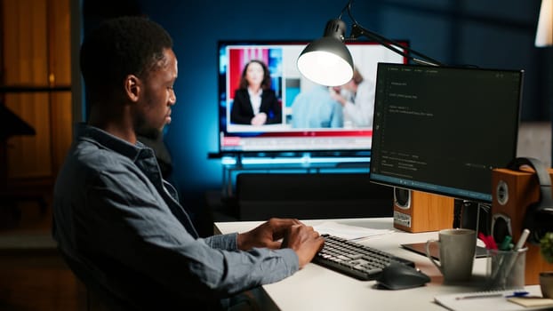 Developer enters binary data on terminal panel while he establishes html code. Software engineer working from home on troubleshooting with programming language, encryption. Camera B.