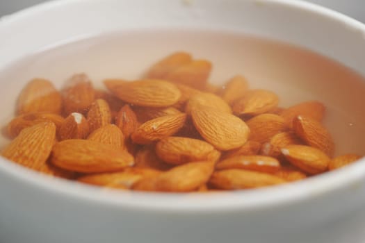 Almonds are being soaked in water to improve their texture and taste.