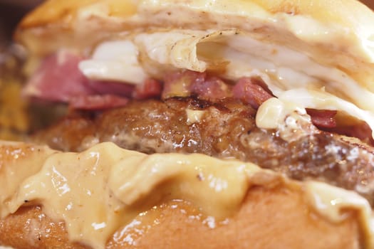 A freshly assembled burger with juicy meat and various toppings served hot.