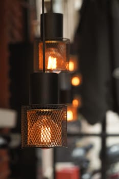 Warm glow of pendant lights enhances cozy urban atmosphere in cafe.