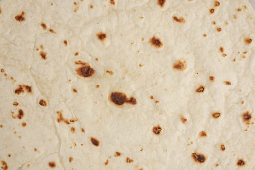 Homemade capati freshly cooked on a hot surface for meals.