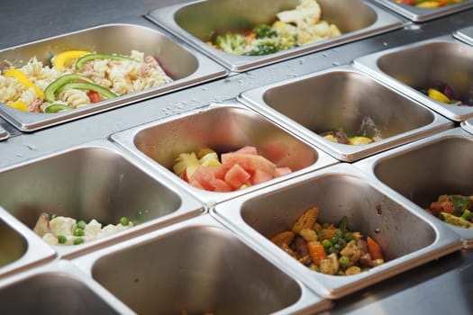 Colorful selection of vegetables and fruits arranged for cooking.