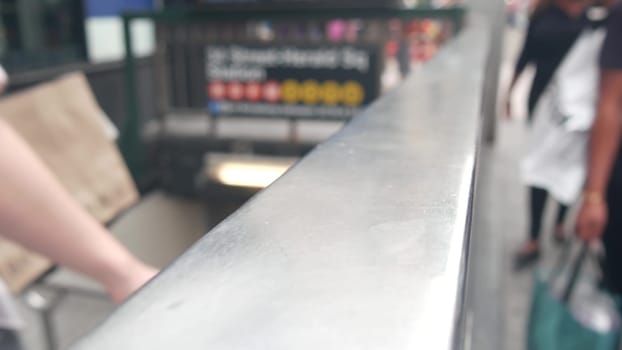 New York City, United States - 29 Aug 2023: Subway sign, underground metro station. Metropolitan entrance fence, public passenger transport exit, text signboard. Pedestrians people on Manhattan street