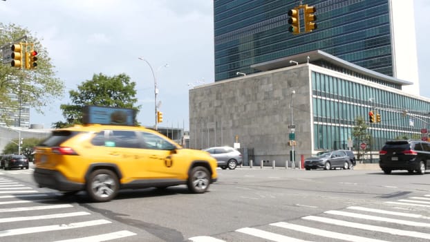 New York City, United States - 4 Sept 2023: United Nations UN Headquarters, Manhattan Midtown, USA. Diplomatic political international organization, General Assembly. Street traffic, yellow taxi car.