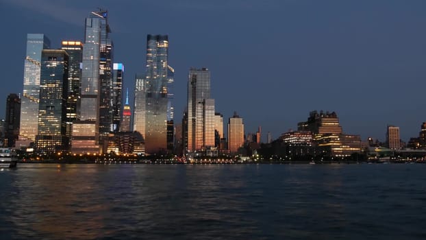 New York City, United States - 4 Sept 2023: Manhattan Midtown skyline from river ferry boat. Hudson Yards skyscrapers from ferryboat. Waterfront panorama riverfront architecture. Empire State Building