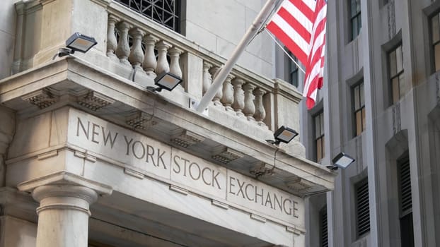 New York City, United States - 4 Sept 2023: Lower Manhattan Downtown Financial District urban architecture. American Flag. Wall street Stock Exchange building, USA Stock Market trading.