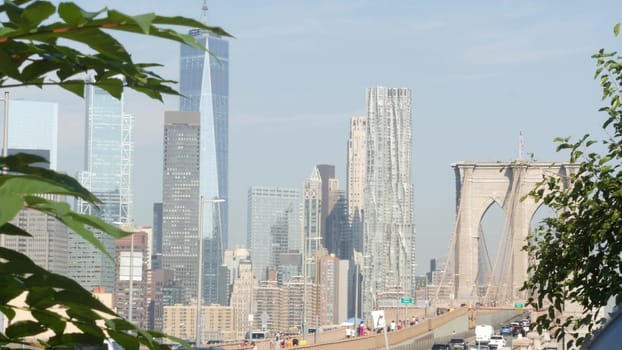 New York City, United States - 3 Sept 2023: Cars on Brooklyn Bridge from Manhattan downtown. Financial district skyline cityscape. Road traffic, people, architecture. World Trade Center skyscraper.
