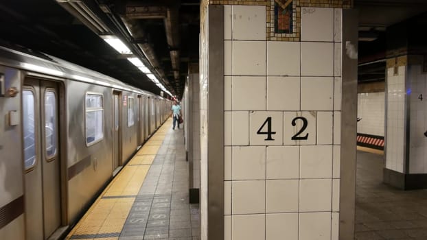 New York City, United States - 29 Aug 2023: Subway station interior, underground metropolitan platform sign. Metro railway train, passenger transport. Text 42 street. Grand Central Terminal, Manhattan