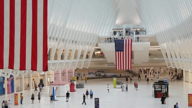 New York City, United States - 10 Sept 2023: World Trade Center Oculus transport hub architecture. Manhattan Downtown Financial District, USA urban life. People. September 11 remembrance american flag