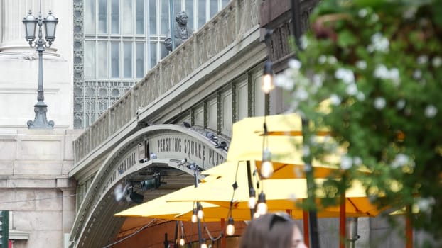New York City, United States - 4 Sept 2023: Grand Central Terminal railway station, 42 street. American Manhattan Midtown. Bridge on Pershing Square, NYC, USA. Light bulb garland, umbrella and flowers